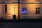 exterior view of the hofburg, through the window one can see a blue neon sign in arabic letters, it is darf outside