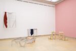 xhibition Kunstpavillon with three aluminium sculptures with fabrics and sculpture made of beige-painted wood reminiscent of high-heeled shoes on clouds