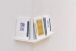 Photo of the exhibition at Kunstpavillon with a publication on a shelf leaning towards the wall,