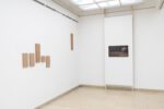 Photo of the exhibition at Kunstpavillon with wooden panels and a video installation